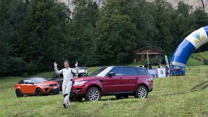 Man standing with 3 Range Rovers 